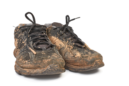 Dirty shoes full of mudの写真素材