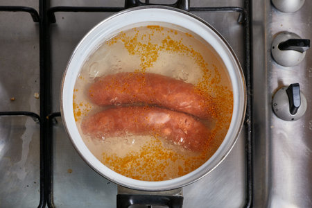Boiling sausages on stoveの写真素材