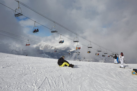 Skiing slopes, with many people