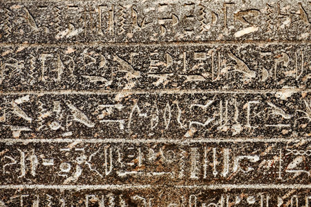 Egyptian hieroglyphs carved in sandstone
