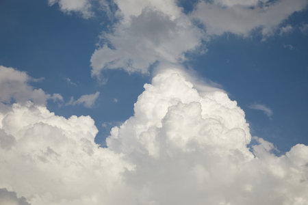 Stormy clouds in the blue sky gathering befor thunderstorm