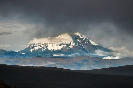 Chimborazo peak in the distance, dark clouds