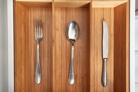 Minimalist kitchen tools put away in a drawerの写真素材