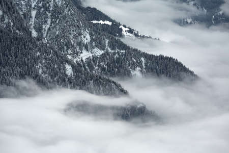 Mountain winter landscape above cloudsの写真素材