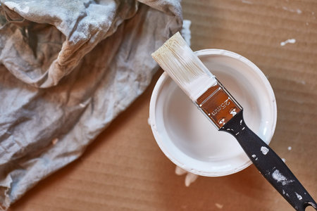 Paint brush on a can of white wall paint