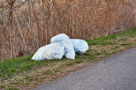 Bags of rubbish on the roadsideの写真素材