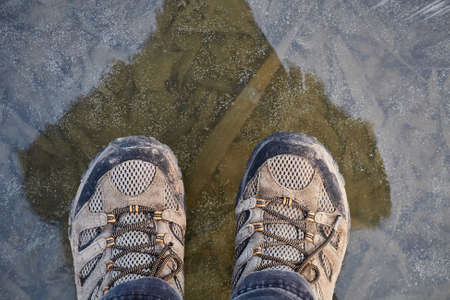 Standing on ice of frozen lakeの写真素材