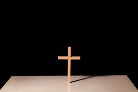 Cross illuminated in the darkの写真素材