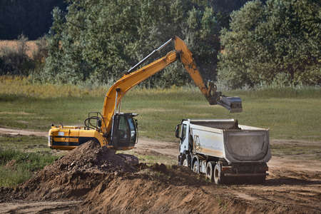 Construction site excavator and truckの写真素材