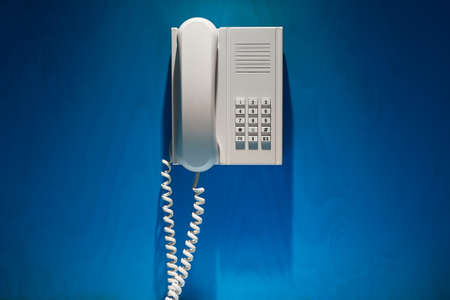 Telefone in harsh spot light on the wallの写真素材