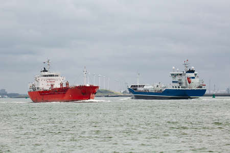 Industrial ships sailing near Rotterdamの写真素材