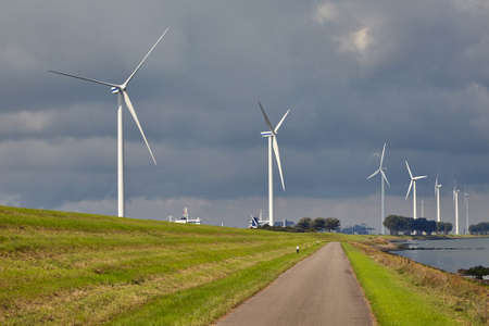 Wind tubines along the watersideの写真素材
