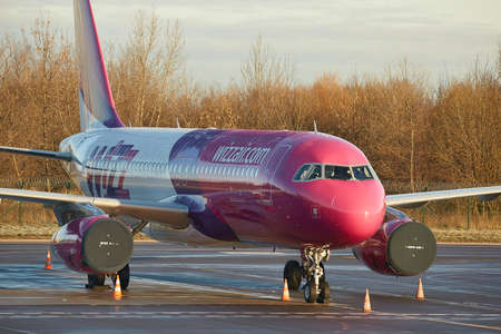 Wizzair airliner parked with engine coversのeditorial素材