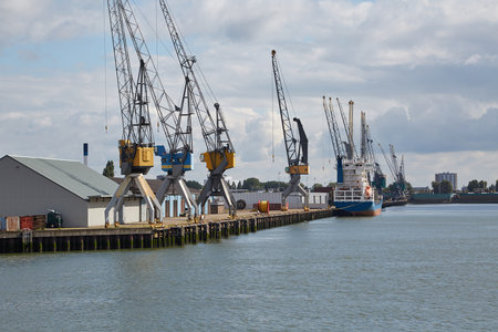 Industrial ships in dock with rotterdam city viewの写真素材