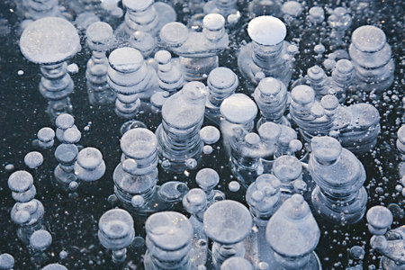 Winter ice with gas bubbles trapped insideの写真素材