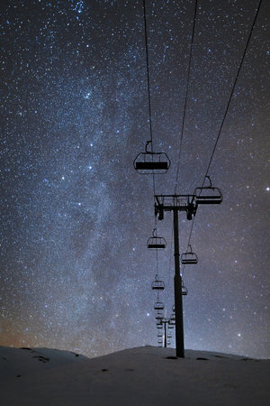 Ski lift at night under the stars in the skyの写真素材