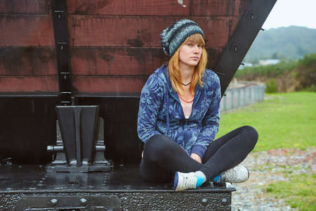 Young woman sitting on a train wagonの写真素材
