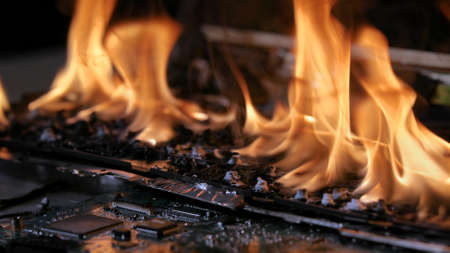 Burning laptop computer electronics closeupの写真素材