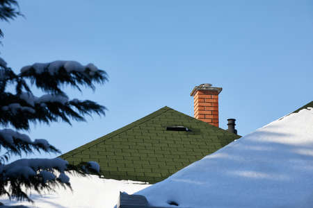Chimnies on a house with snowの写真素材