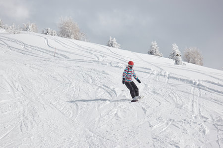 Female snowboarder on the slopeの写真素材