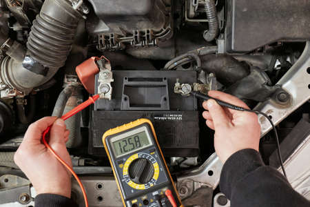 Checking car battery voltage on a carの写真素材