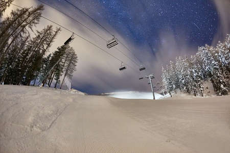 Ski lift at night under the stars in the skyの写真素材