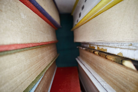 Piled up books macro view between themの写真素材
