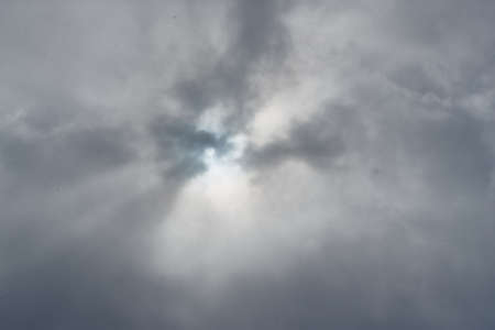 Cloudy sky snow falling from aboveの写真素材