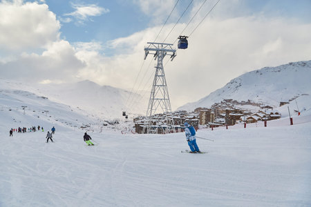 Skiing slopes, with many people