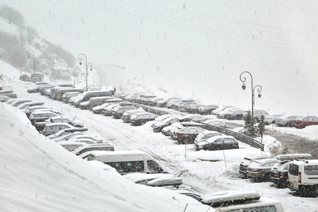 Snowy mountain skiing village, falling snowの写真素材