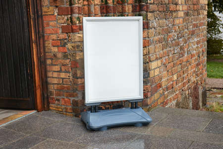 White sign board at old brick building entranceの写真素材