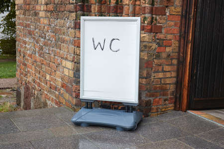 WC sign board at old brick building entranceの写真素材
