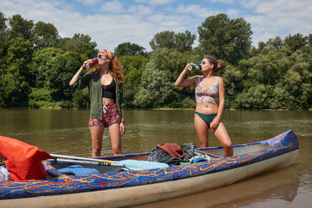 Drinking beer in sunshine on a canoe tripの写真素材