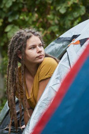 Woman getting out the tent