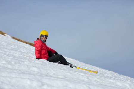 Skier resting on the slope