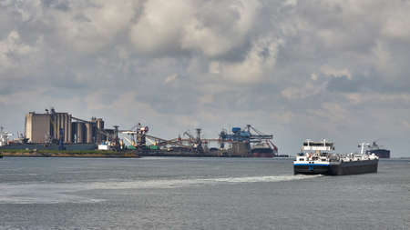 Industrial ship leaving Rotterdamの写真素材
