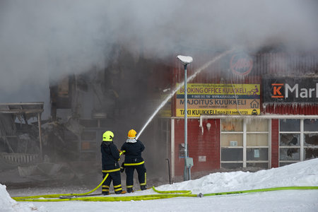 Burning shopping center, firefighters workingのeditorial素材