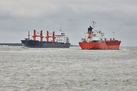 Industrial ships sailing near Rotterdamの写真素材