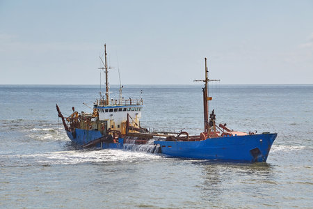 Dredging ship at a sea portの写真素材
