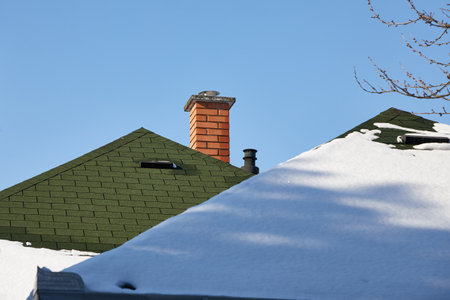 Chimnies on a house with snowの写真素材