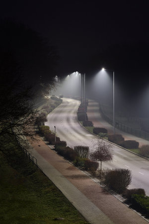 Foggy Road at nightの写真素材