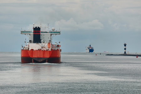 Industrial ships sailing near Rotterdamの写真素材