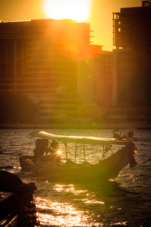 Sunset and a long tail boat  on the Chao phraya riverの写真素材