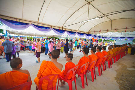 ANG THONG, THAILAND - APRIL 15,2013   Thai people sprinkle water onto a Buddha image and pour water onto monks There are the gesture of worship during the annual Songkran festival at Wat Nangnai Thammikaram on April 15, 2013 in Ang thong,Thailand のeditorial素材