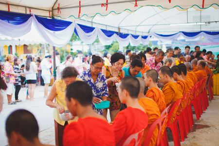 ANG THONG, THAILAND - APRIL 15,2013   Thai people sprinkle water onto a Buddha image and pour water onto monks There are the gesture of worship during the annual Songkran festival at Wat Nangnai Thammikaram on April 15, 2013 in Ang thong,Thailand のeditorial素材