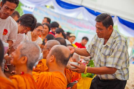 ANG THONG, THAILAND - APRIL 15,2013   Thai people sprinkle water onto a Buddha image and pour water onto monks There are the gesture of worship during the annual Songkran festival at Wat Nangnai Thammikaram on April 15, 2013 in Ang thong,Thailand のeditorial素材