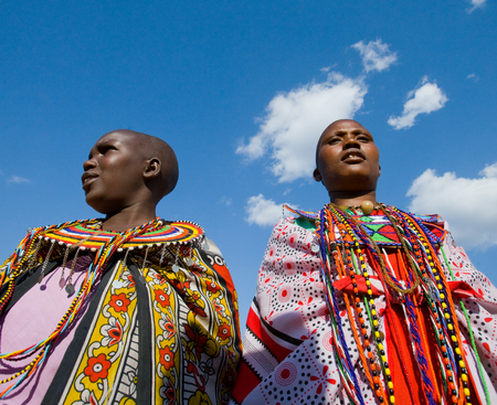 KENYA, MASAI MARA - JULY 19, 2011: Maasai women together singing ritual songs in traditional dress.のeditorial素材