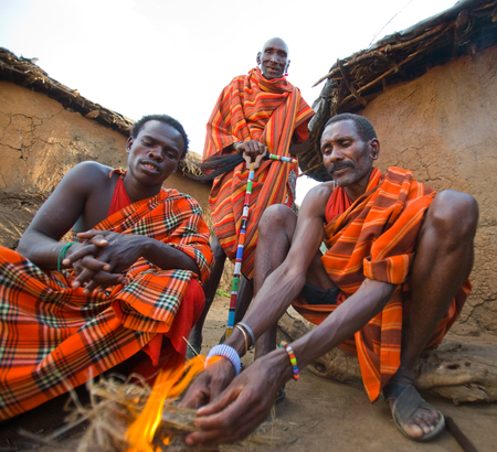 KENYA, MASAI MARA - JULY 19, 2011: Men Masai tribe make a fire in the traditional way.のeditorial素材
