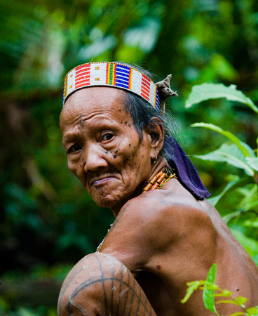 MENTAWAI PEOPLE, WEST SUMATRA, SIBERUT ISLAND, INDONESIA - 16 NOVEMBER 2010: Portrait of a man Mentawai tribe in traditional headdress.のeditorial素材