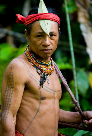 MENTAWAI PEOPLE, WEST SUMATRA, SIBERUT ISLAND, INDONESIA - 16 NOVEMBER 2010: Portrait of a man Mentawai tribe. Close-up.のeditorial素材